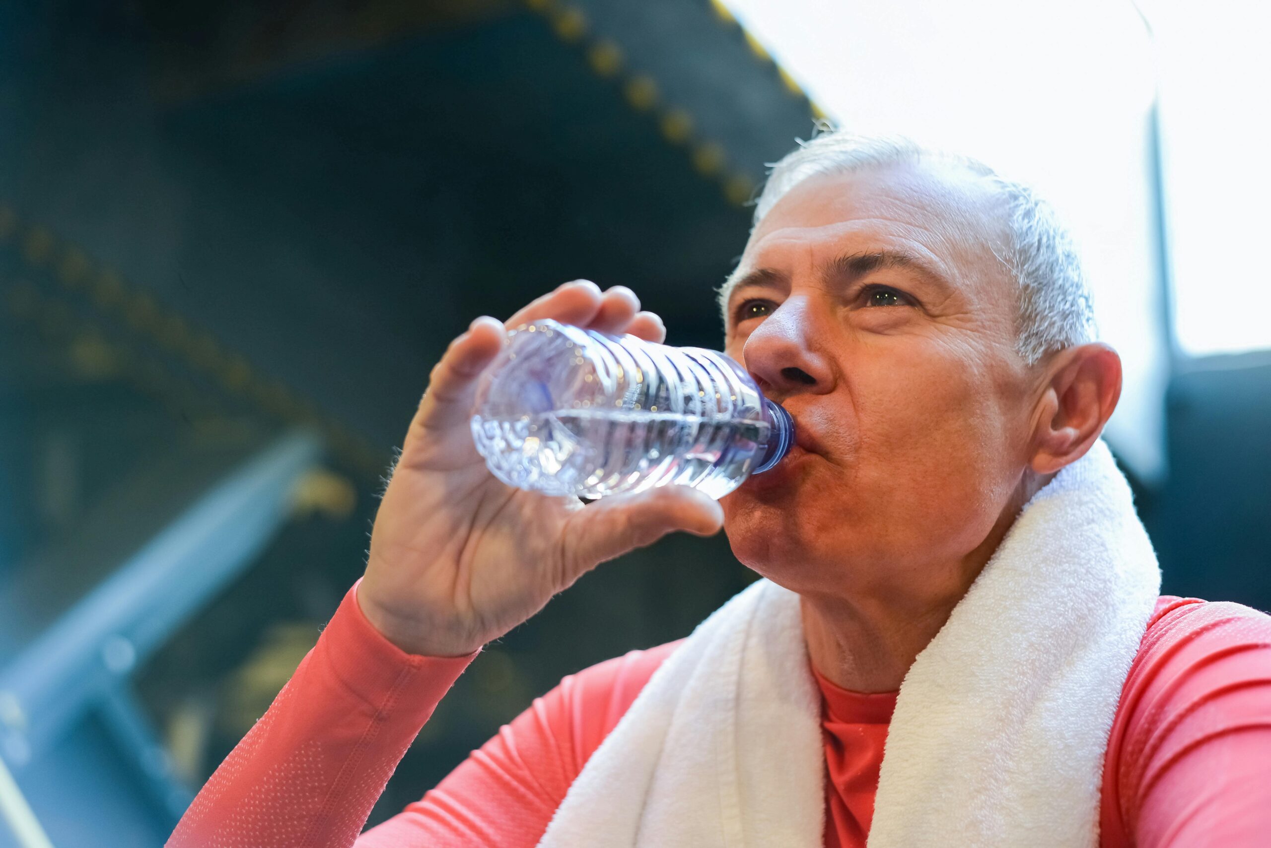 man drinking from water bottle